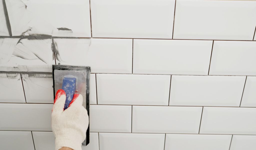 Mortar being used to point bathroom tiles