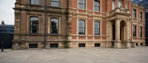 Weathered brick and stone facade with a cleaner restored section