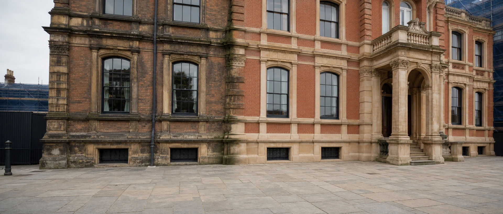 Weathered brick and stone facade with a cleaner restored section
